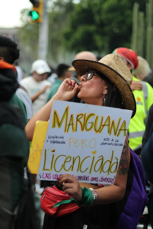 a woman with a sign and other people standing around