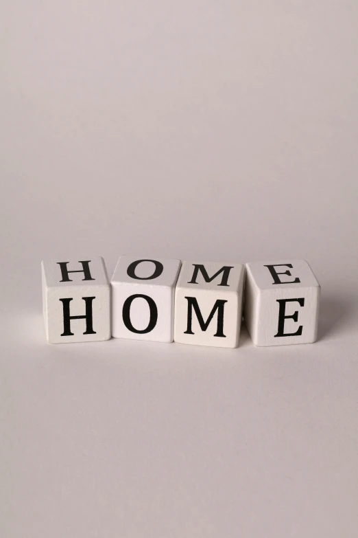 three white and black letters that spell out the words home