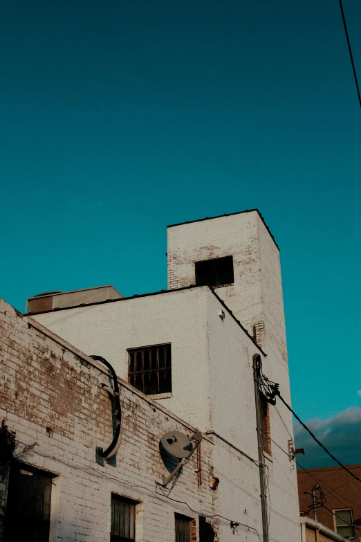 a po of an old building with some wires and a clock