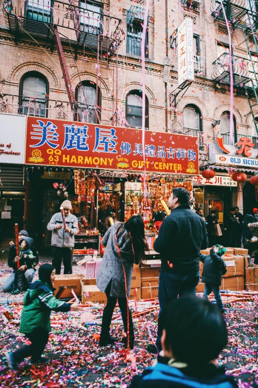 a street filled with people near a large building