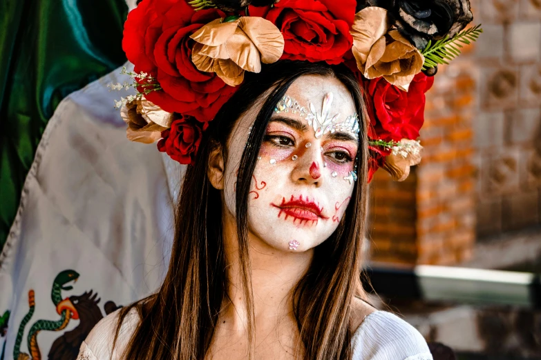 a girl in white makeup with roses on her head