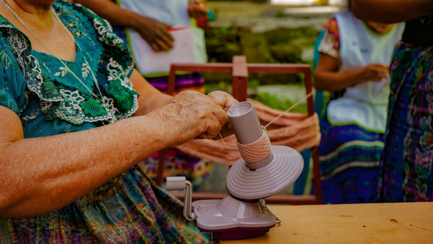 a person weaving soing with scissors on a machine