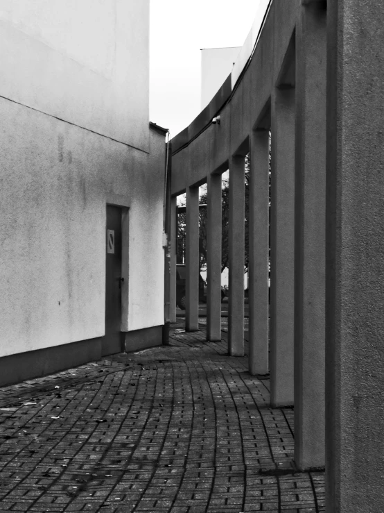 a long line of brick street lined with cement pillars