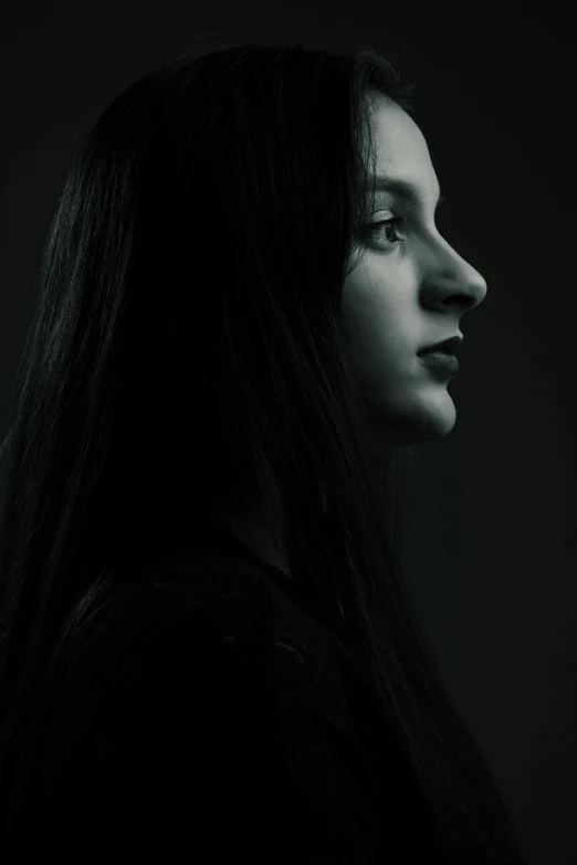 a woman with long dark hair looking to the side