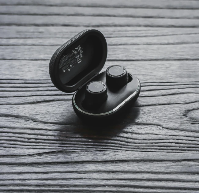 an empty earphone on a wooden surface