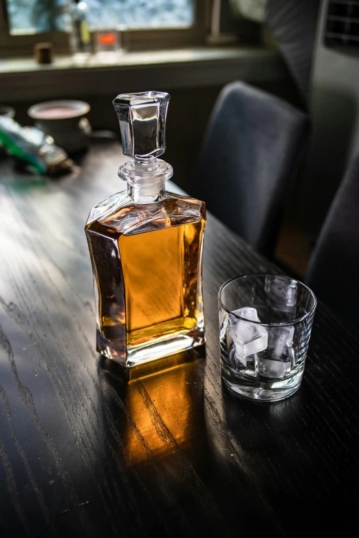an empty bottle of whiskey sits on a table