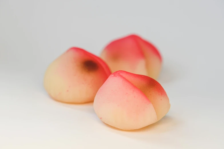 peaches with slices taken out on white table