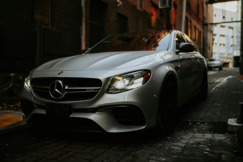 a silver car parked on the street next to buildings