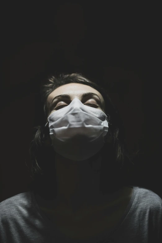 a woman wearing a mask with no filter in the dark