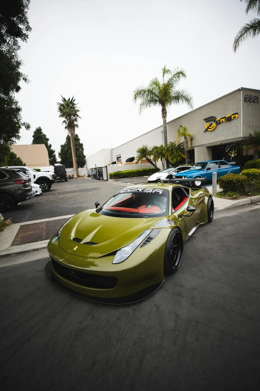 two green cars are parked in front of the building