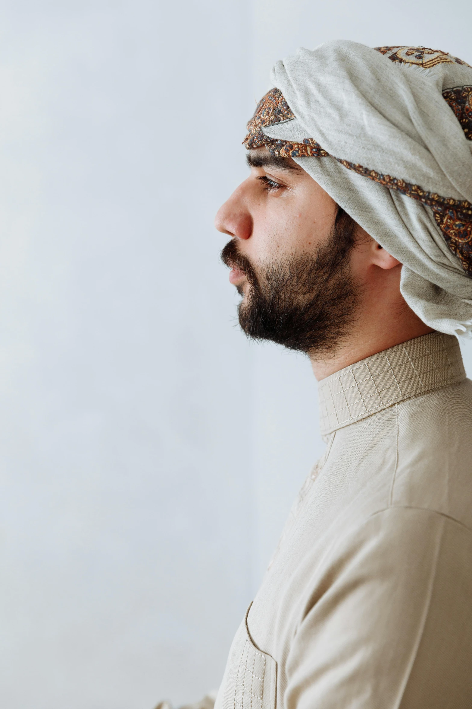 a man wearing a hat with the head covering over his face