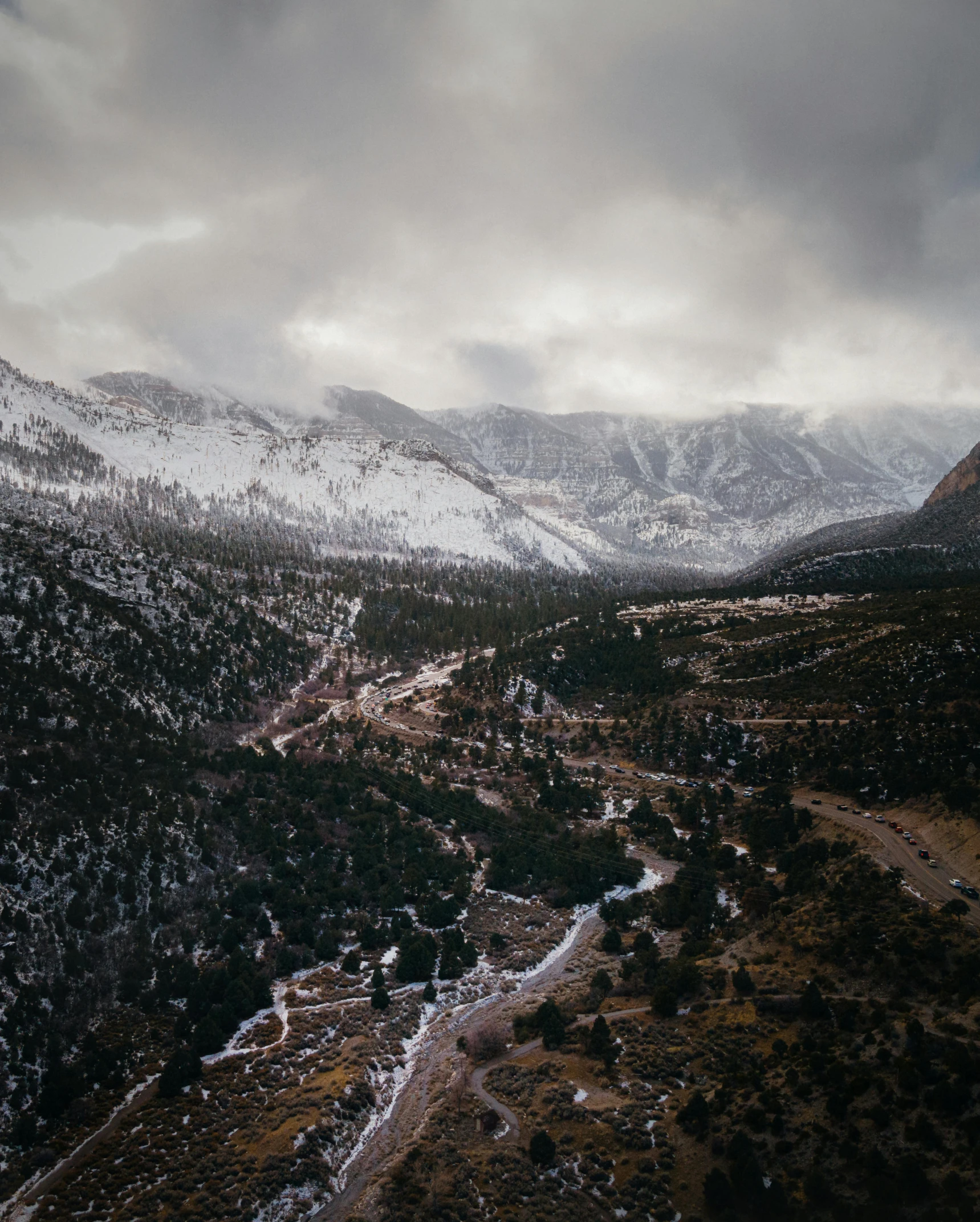 view from the top of a mountain to a snowy valley