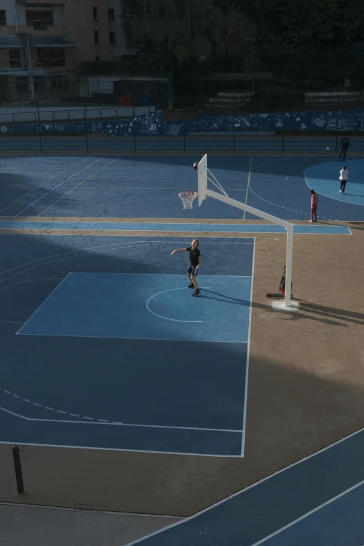 an aerial s of people playing basketball on court