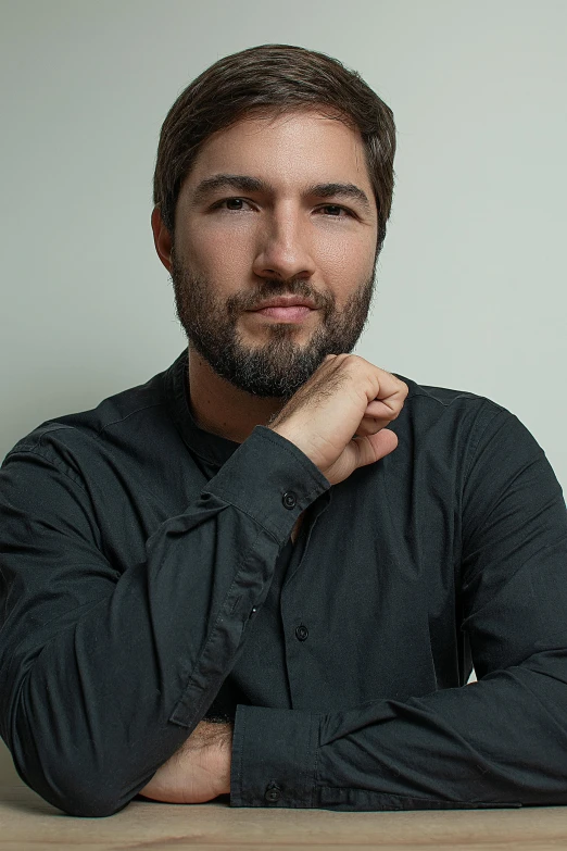 a man with a beard is sitting at a table