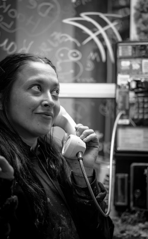 a woman smiling while talking on the phone