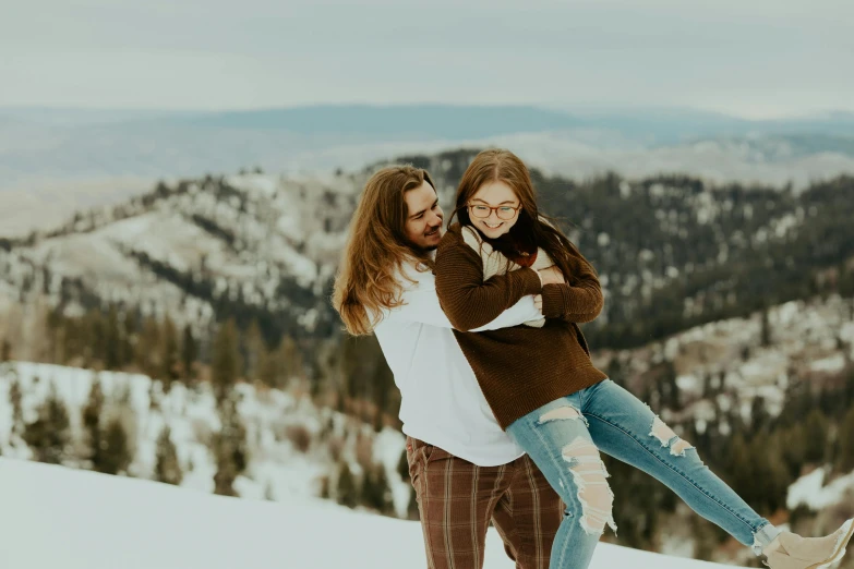 a woman in brown sweater carrying another woman