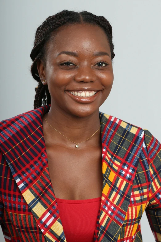 smiling young black female with plaid jacket and bright smile