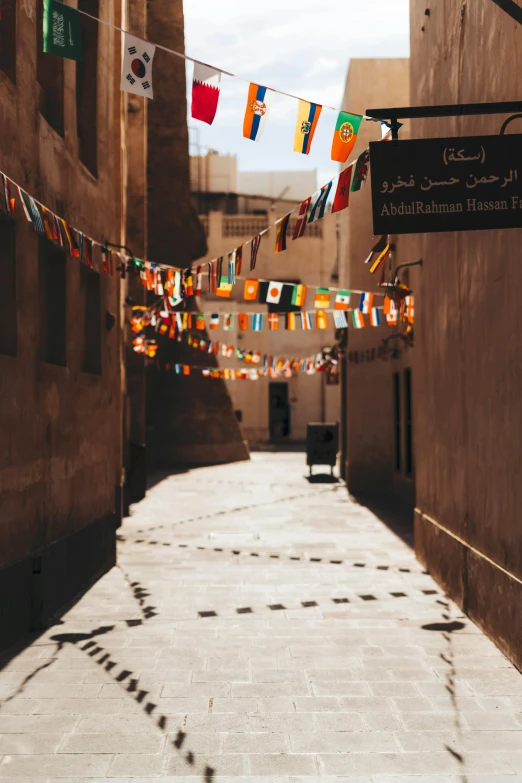 flags on the clothesline line hanging on buildings in a narrow city