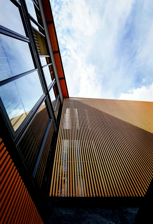 looking up into a building with two tall windows