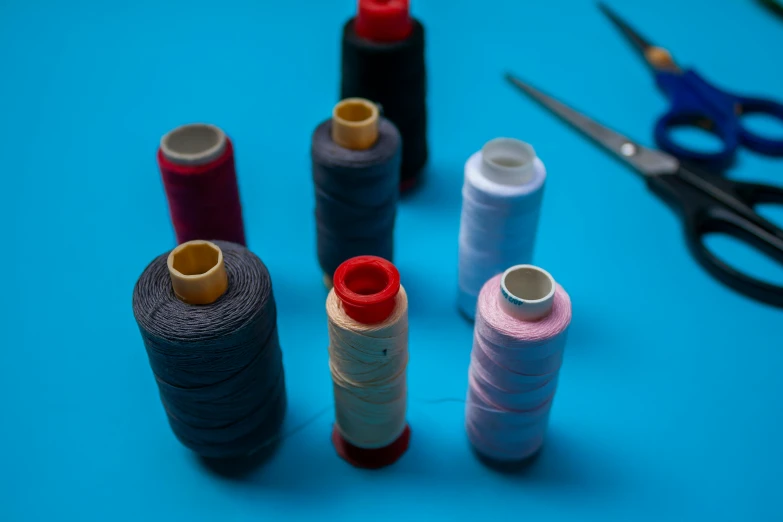 a blue table filled with sewing and craft items