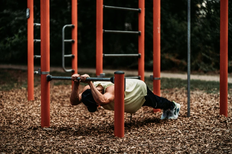 an older man does hups on a bar set