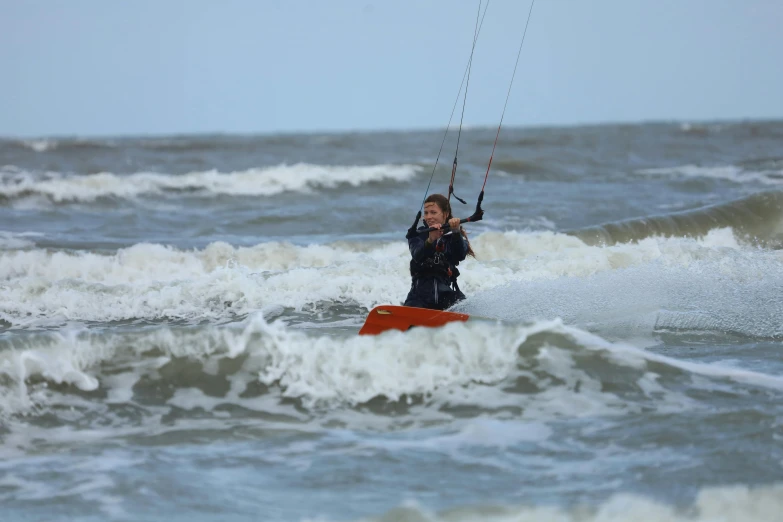 the man is surfing in a body of water