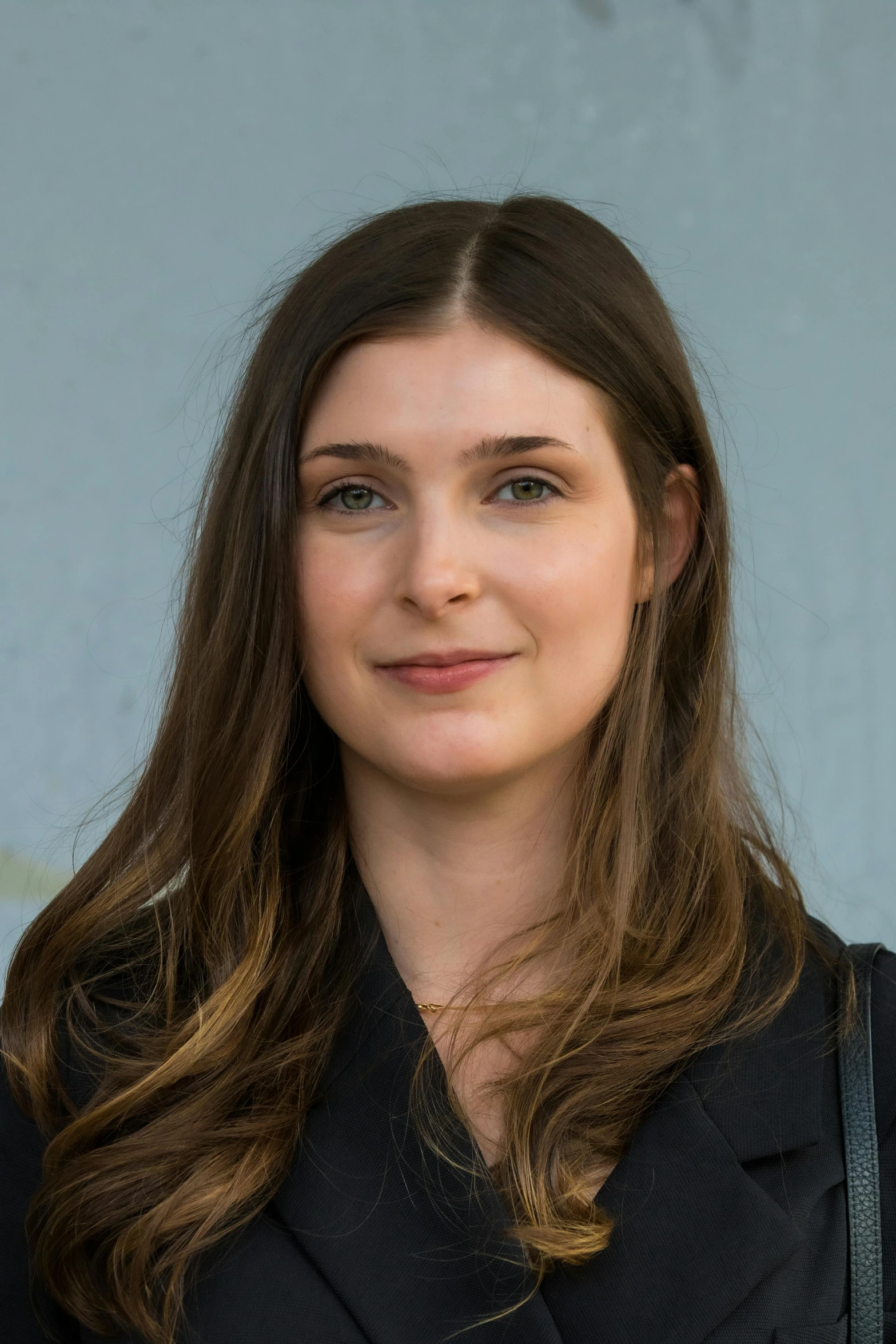 a woman is smiling for the camera with long hair