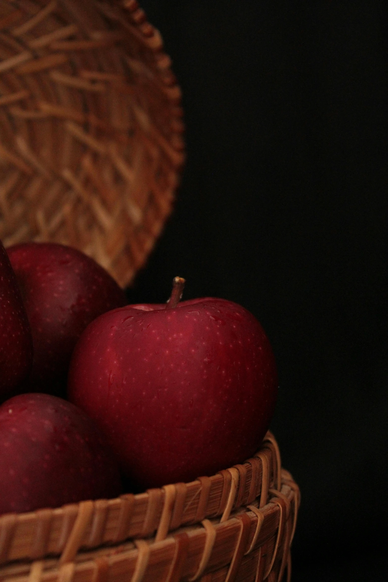 a basket full of red apples on top of a table