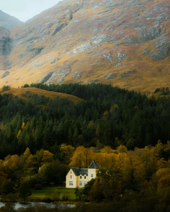 this house is located in the mountains beside a lake