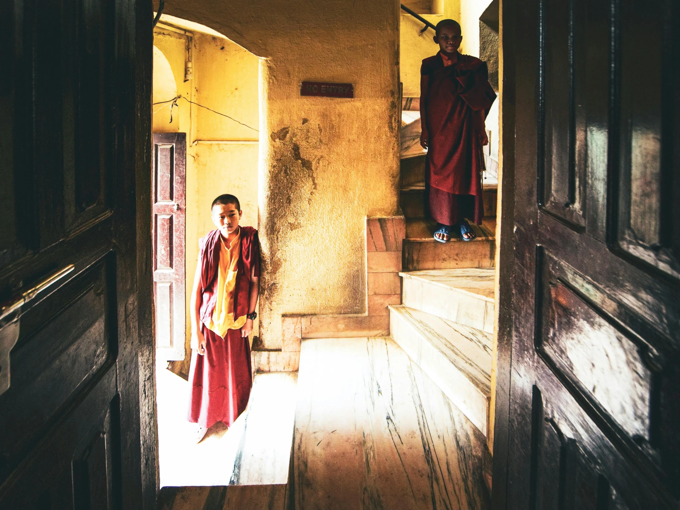 a monk standing at the doorway to another monk