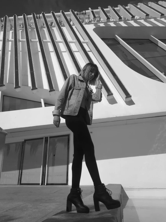 black and white pograph of woman in front of building