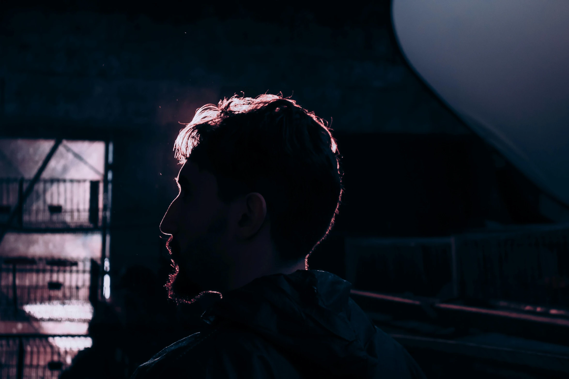 a man standing in front of some doors and looking at the sky