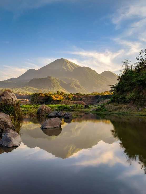 mountains are in the distance and their reflection in the still waters