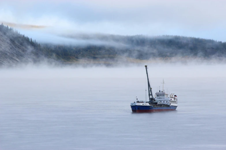 the boat is floating alone on the water