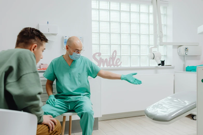 two people in hospital scrubs sit next to each other