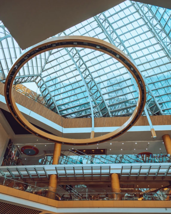 an atrium with a large clock on the ceiling