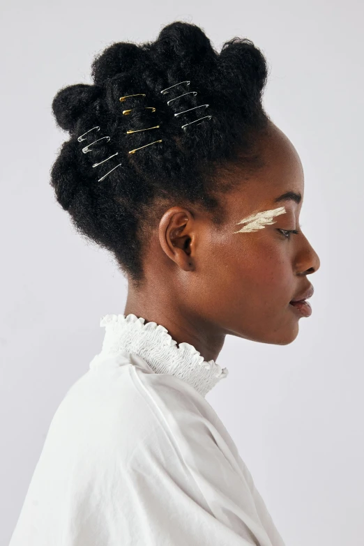 a black woman with some hair pins in her head