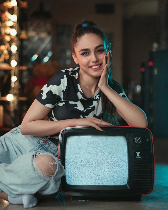 a girl kneeling down with a remote to her head