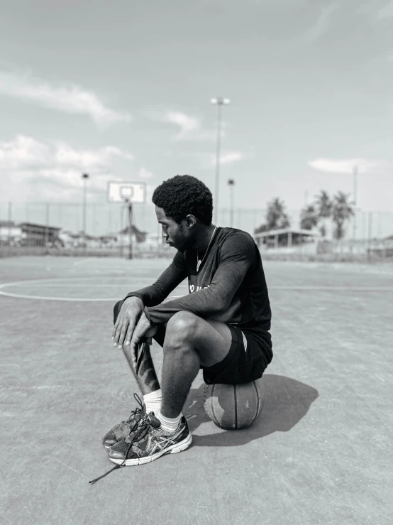 man sitting in the middle of the court at the same time