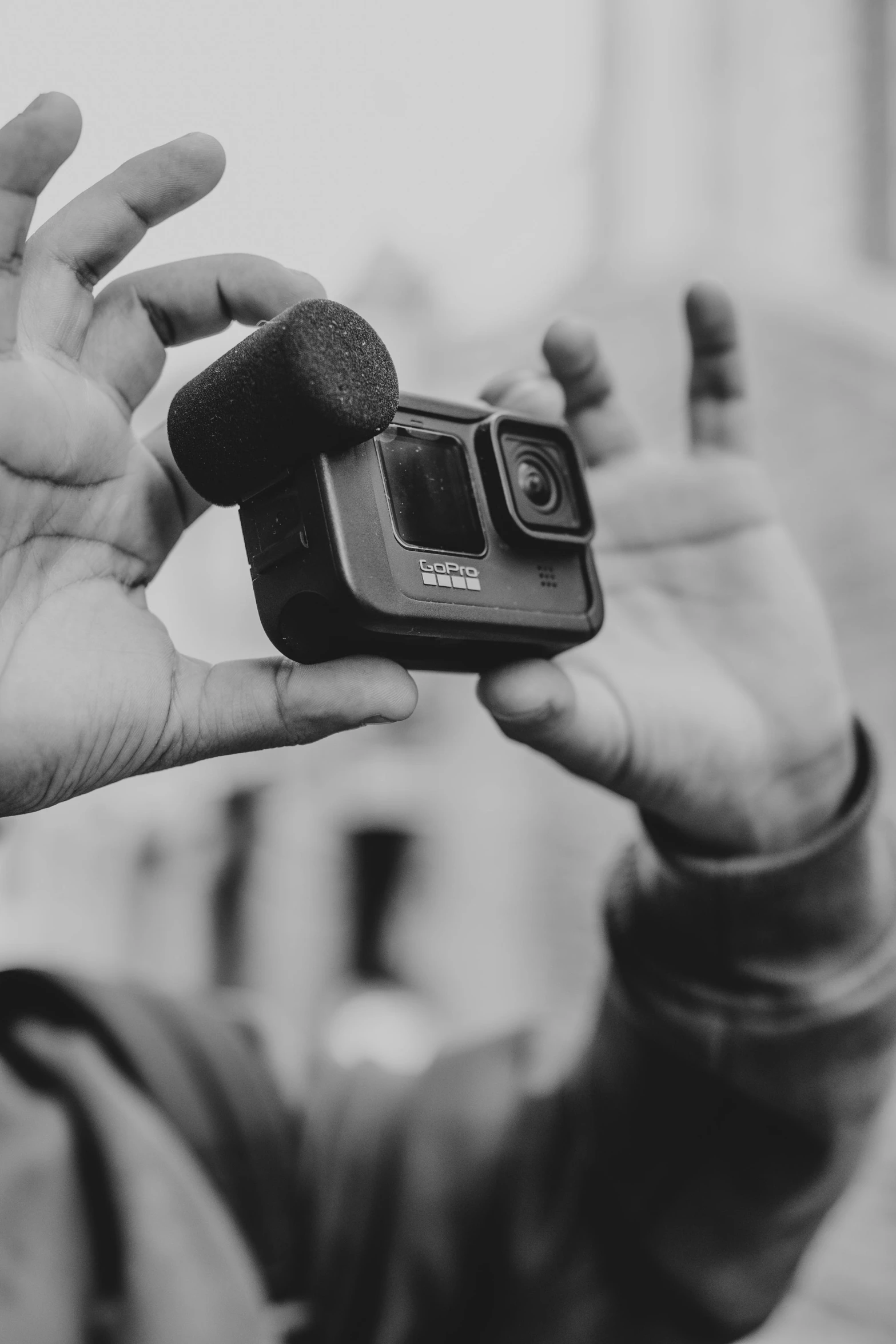 a man that is holding a small object in his hand