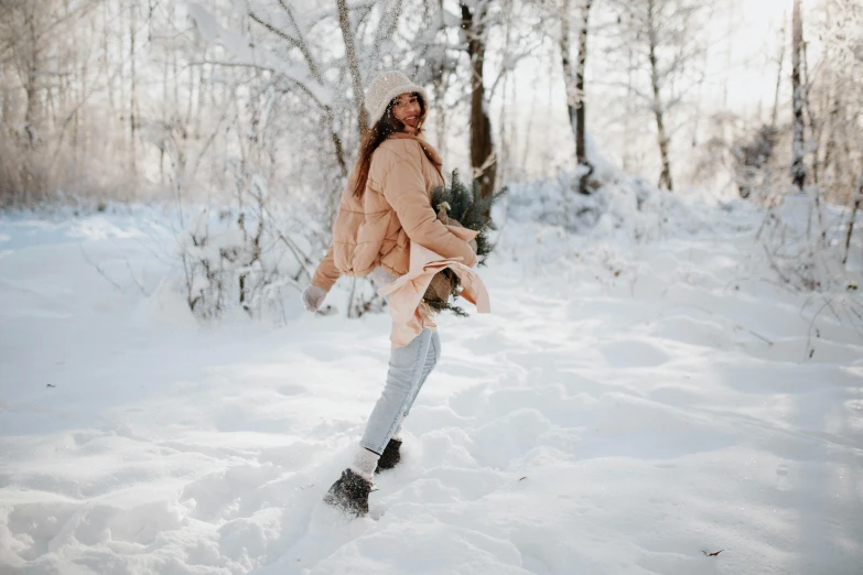 a woman is doing snowboarding in the middle of a snowy forest