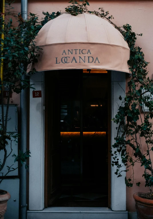 there is a doorway to a restaurant with plants growing outside