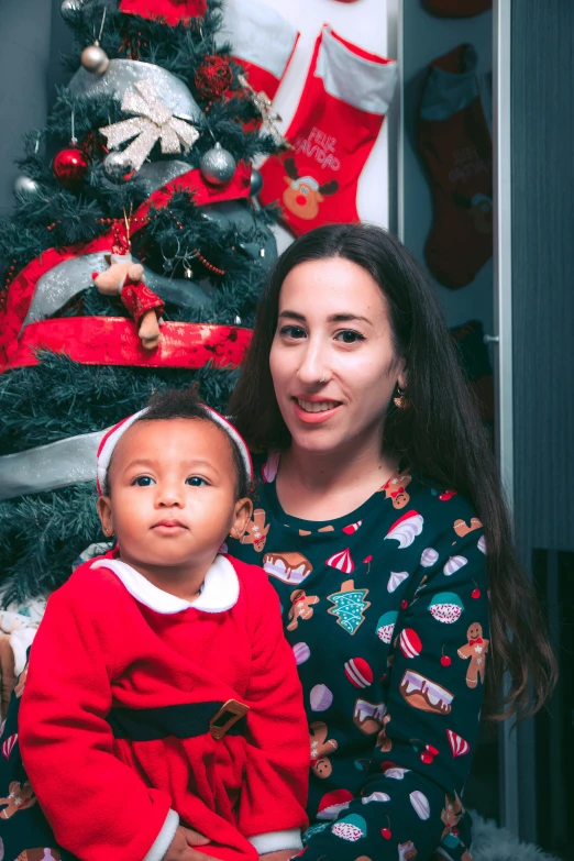 there is a woman holding a baby and posing for the camera