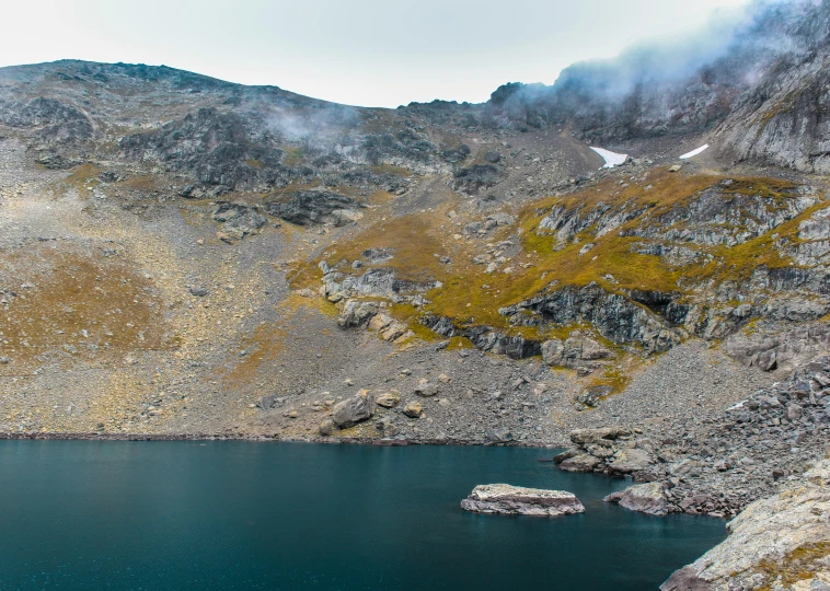 this is a mountain with water and fog