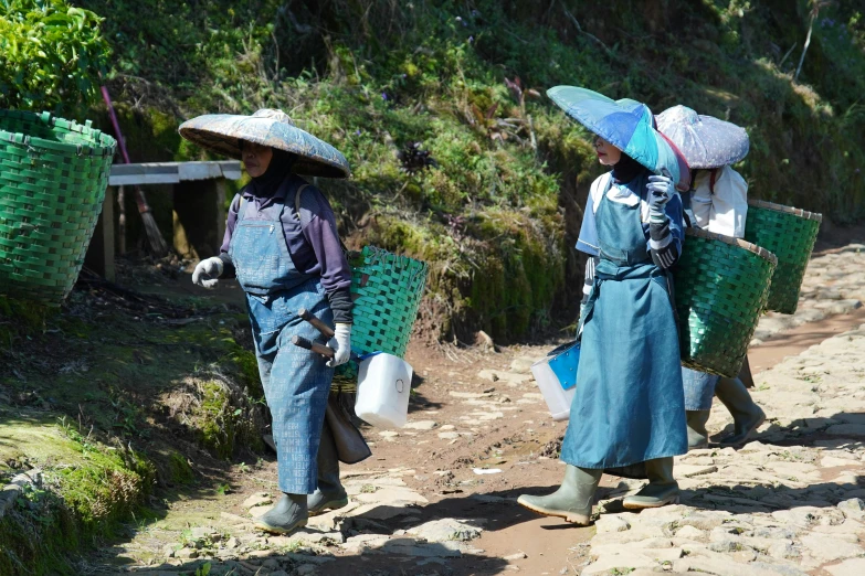 two women walking down the street with bags on their heads