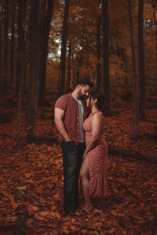 an image of a couple cuddling in the woods