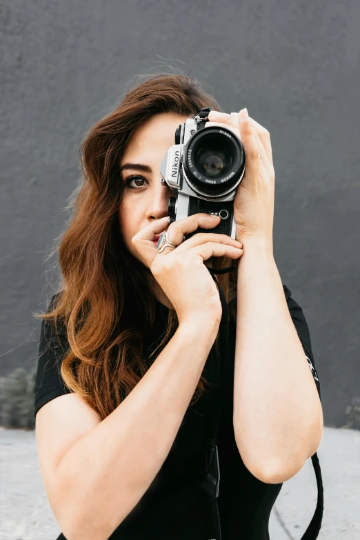 a woman is taking a picture with her camera