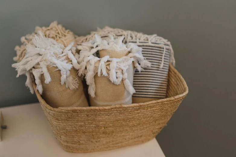 a basket holding several pairs of brown and white shoes