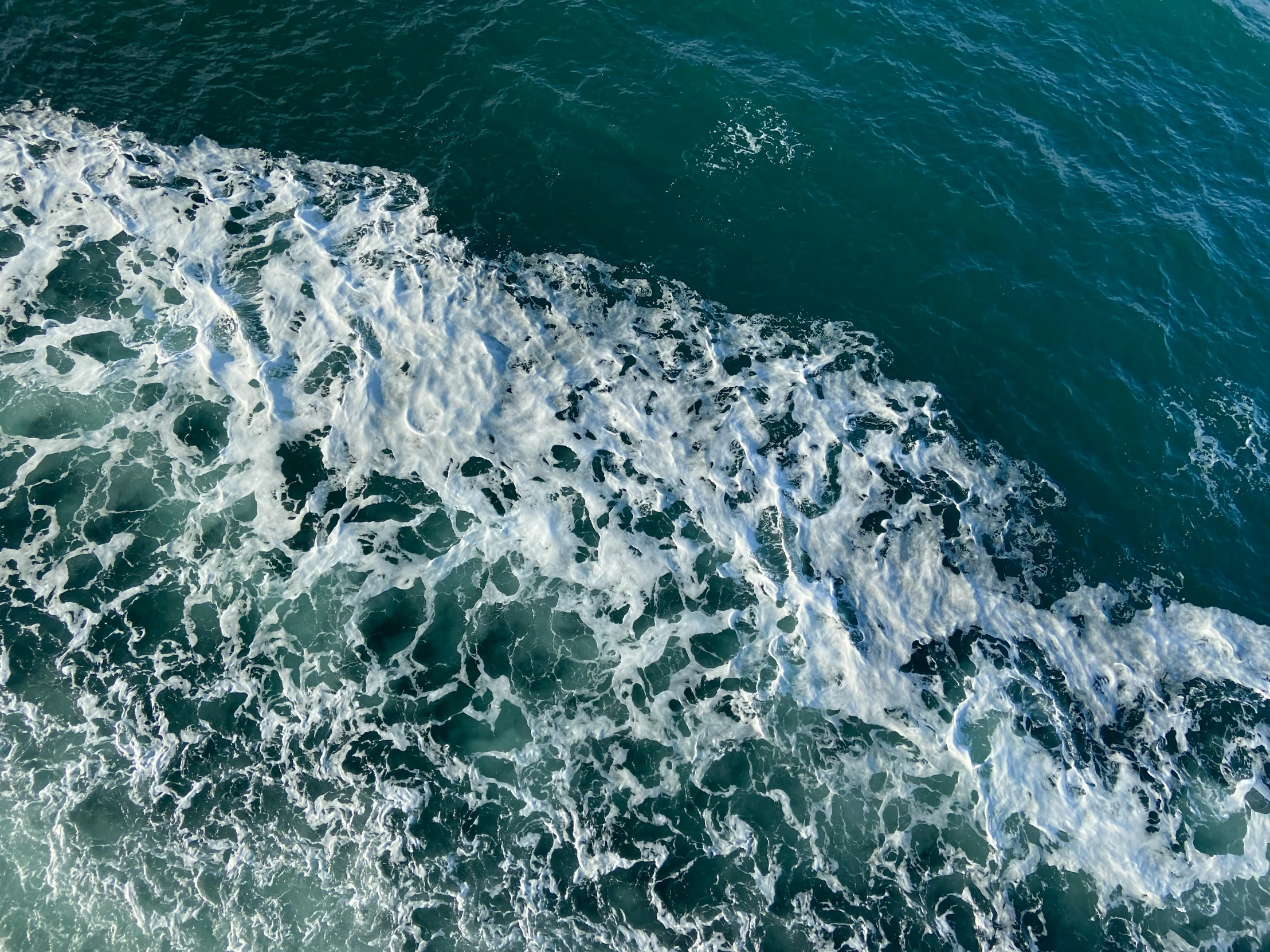 a view of the ocean water from a plane