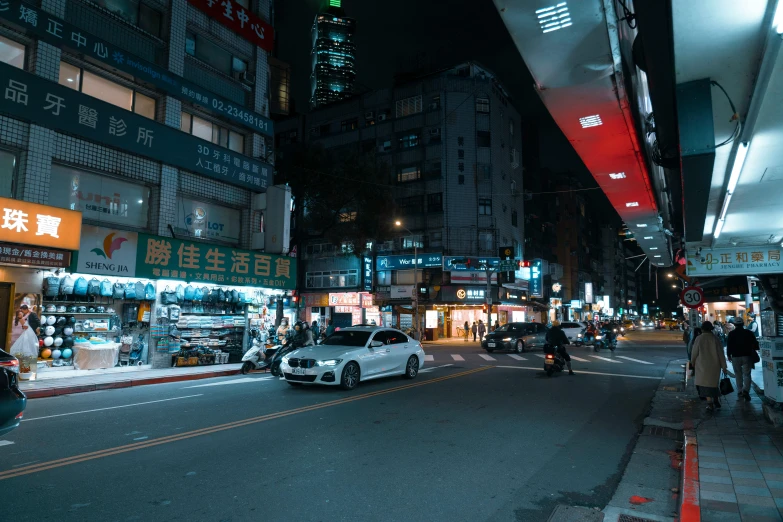 people are walking in the street at night